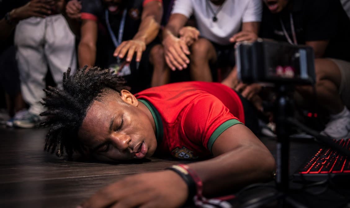 Popular streamer Darren Watkins Jr. lying collapsed on the floor during a livestream as shocked people rush to help, capturing a tense moment of a viral streaming incident.